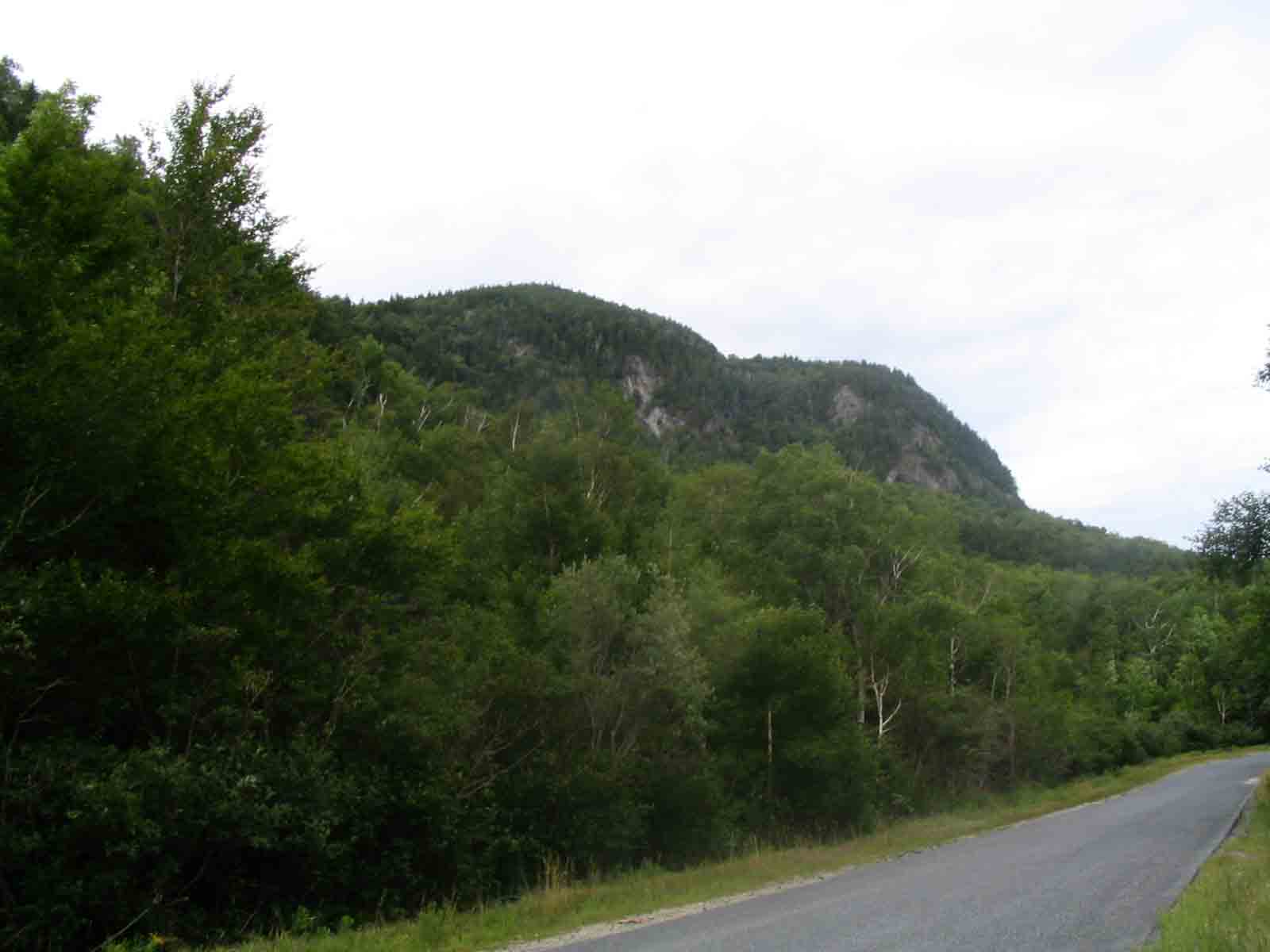 13.3 MM. This is South Arm Road in Black Brook Notch. You are looking at the cliffs the AT comes down southbound. You drop off 900 feet in 0.6 mile. If you follow South Arm Road in the direction shown in this photo, it is 8 miles to Andover, ME. The last trail town in Maine. Courtesy askus3@optonline.net